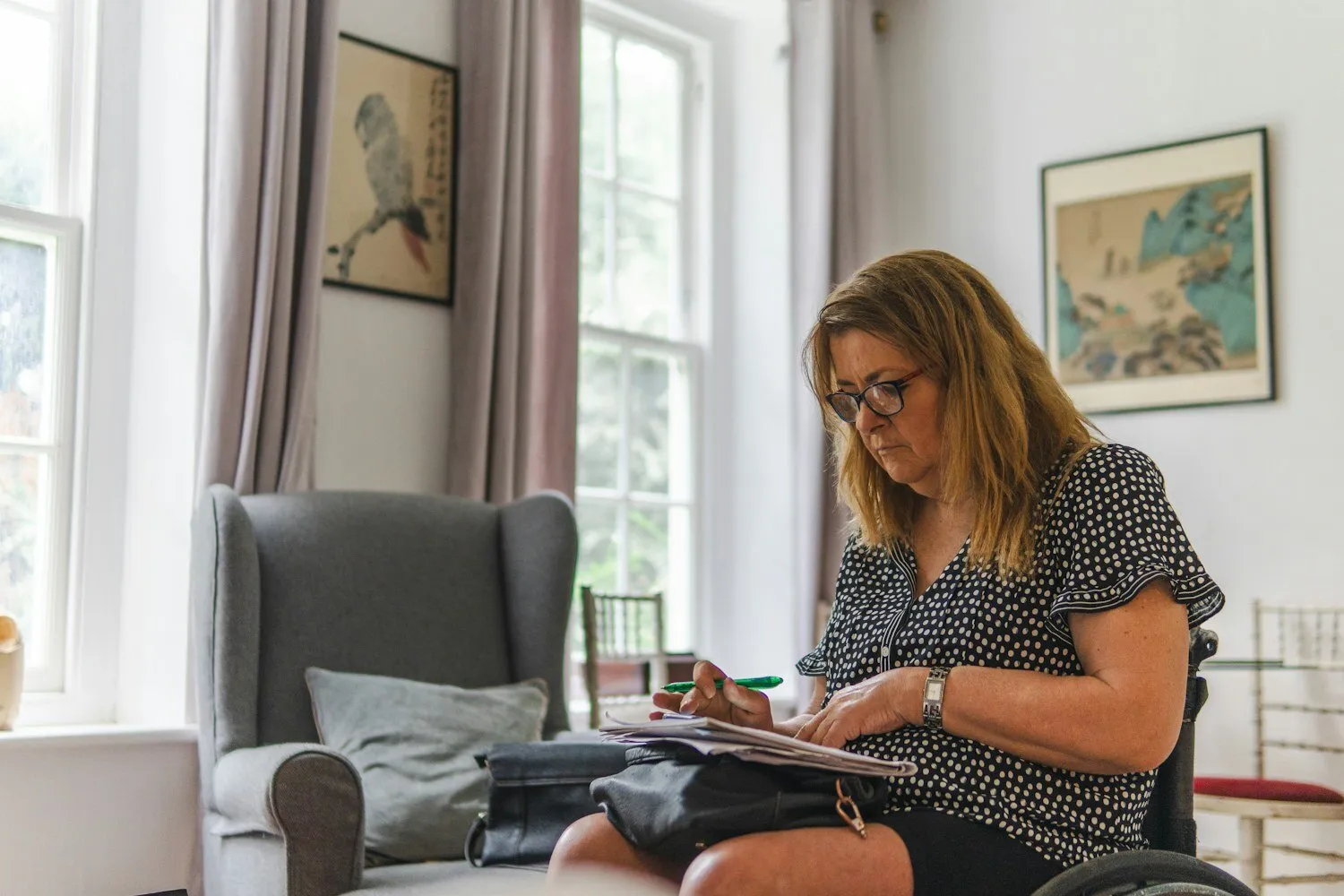 A nurse filling out paperwork during a home visit.